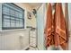 Bathroom featuring white tile, shower, and decorative accents at 5704 Ammons St, Arvada, CO 80002