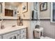 Bathroom featuring white tile, vanity, and decorative accents at 5704 Ammons St, Arvada, CO 80002