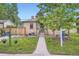 A charming brick home is showcased with a well-manicured lawn and a neatly paved walkway at 5704 Ammons St, Arvada, CO 80002