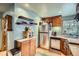 Cozy kitchen featuring stainless steel appliances, wood cabinets, and a practical layout at 5704 Ammons St, Arvada, CO 80002