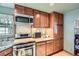 Cozy kitchen with wood cabinets, stainless steel appliances, and tile backsplash at 5704 Ammons St, Arvada, CO 80002