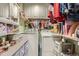 Well-organized laundry room with washer, dryer, storage cabinets, and shelving for efficient laundry at 5704 Ammons St, Arvada, CO 80002