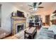 Comfortable living room featuring a brick fireplace and an open floor plan to the dining area at 5704 Ammons St, Arvada, CO 80002