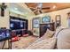 Comfortable living room featuring wood ceiling, ceiling fan, and entertainment center at 5704 Ammons St, Arvada, CO 80002