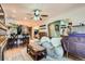 Bright living room with hardwood floors and views of the adjacent dining and kitchen areas at 5704 Ammons St, Arvada, CO 80002