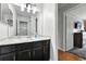 Bathroom featuring black vanity, marble countertop, and updated fixtures at 19616 E Milan Cir, Aurora, CO 80013