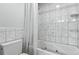 Updated bathroom featuring a jetted tub with shower and tile walls at 19616 E Milan Cir, Aurora, CO 80013