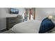 Bedroom with view through french doors, dresser, and flat screen TV at 19616 E Milan Cir, Aurora, CO 80013