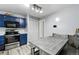 Cozy dining area connected to kitchen features blue cabinets, stainless appliances, and a large table at 19616 E Milan Cir, Aurora, CO 80013
