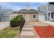 Charming townhome featuring a stone facade, well-manicured landscaping, and a welcoming front entrance at 19616 E Milan Cir, Aurora, CO 80013