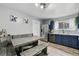 Kitchen boasts stainless steel appliances, blue cabinets, and wood-style floors at 19616 E Milan Cir, Aurora, CO 80013