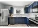 Modern kitchen features stainless steel appliances, blue cabinetry, and sleek countertops at 19616 E Milan Cir, Aurora, CO 80013