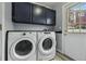 Laundry room includes a Whirlpool washer and dryer and storage at 19616 E Milan Cir, Aurora, CO 80013