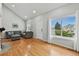 Inviting living room with hardwood floors, a vaulted ceiling, and large window, providing ample natural light at 19616 E Milan Cir, Aurora, CO 80013