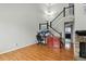 Bright living room features hardwood floors, a staircase, vaulted ceiling, and work space at 19616 E Milan Cir, Aurora, CO 80013