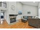 Living room showcasing a stone fireplace, hardwood floors, vaulted ceiling, and cozy seating area at 19616 E Milan Cir, Aurora, CO 80013