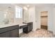 Bathroom with double vanity, quartz countertop, and shower at 250 Paloma Way, Elizabeth, CO 80107