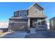 Two-story home with gray siding, stone accents, and a two-car garage at 250 Paloma Way, Elizabeth, CO 80107