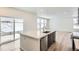 Kitchen island with sink, dishwasher, and view to backyard at 250 Paloma Way, Elizabeth, CO 80107