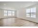 Bright living room with hardwood floors and large windows at 250 Paloma Way, Elizabeth, CO 80107