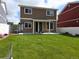 Large backyard features a lawn, covered patio, and privacy fence at 20768 Randolph Pl, Denver, CO 80249