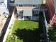 Aerial view of a fully fenced backyard with a covered patio and lush lawn at 20768 Randolph Pl, Denver, CO 80249