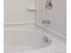 A clean, white bathtub with chrome fixtures and white tiled walls creates a refreshing and modern bathing space at 20768 Randolph Pl, Denver, CO 80249