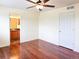 Spacious bedroom with hardwood floors and ceiling fan at 20768 Randolph Pl, Denver, CO 80249