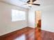 Bright bedroom with hardwood floors, a ceiling fan, and a window at 20768 Randolph Pl, Denver, CO 80249