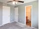 Bedroom with carpet, ceiling fan, two closets and an ensuite bathroom with wood vanity at 20768 Randolph Pl, Denver, CO 80249