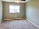 An inviting bedroom features neutral paint and carpet, a ceiling fan, and a window offering pleasant neighborhood views at 20768 Randolph Pl, Denver, CO 80249