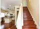 Inviting entryway featuring hardwood floors, stairs, and a view into the spacious kitchen with an island at 20768 Randolph Pl, Denver, CO 80249