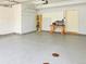 Clean two-car garage with shelving, work bench and finished floor at 20768 Randolph Pl, Denver, CO 80249