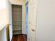 Hallway with hardwood floors, open closet, and white doors at 20768 Randolph Pl, Denver, CO 80249