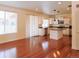 Spacious kitchen with stainless steel appliances, a center island, and rich hardwood floors at 20768 Randolph Pl, Denver, CO 80249