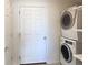 Convenient laundry room includes a stacked washer and dryer, plus storage shelves at 20768 Randolph Pl, Denver, CO 80249