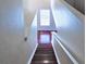 Bright stairway with wood floors and white railing, leading to the lower level at 20768 Randolph Pl, Denver, CO 80249