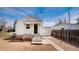 Exterior back elevation featuring a patio and grassless yard at 4325 S Cherokee St, Englewood, CO 80110