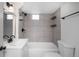 Cozy bathroom featuring white tiled shower and sink with dark hardware and bright lighting at 4325 S Cherokee St, Englewood, CO 80110