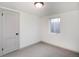 Neutral bedroom featuring a bright window and door with carpeted floors at 4325 S Cherokee St, Englewood, CO 80110