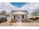 Charming front exterior featuring a quaint porch and well-maintained rock garden at 4325 S Cherokee St, Englewood, CO 80110