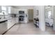 Well-equipped kitchen with stainless steel appliances, subway tile backsplash, and a view to the connecting room at 4325 S Cherokee St, Englewood, CO 80110