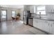 Open-concept kitchen seamlessly flows into the dining area, featuring modern appliances and ample counter space at 4325 S Cherokee St, Englewood, CO 80110