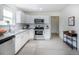 Updated kitchen featuring stainless steel appliances, granite countertops, and stylish subway tile backsplash at 4325 S Cherokee St, Englewood, CO 80110