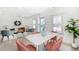 Open concept living space with dining area, comfortable seating, and abundant natural light from multiple windows at 4325 S Cherokee St, Englewood, CO 80110
