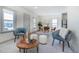 Inviting living space with modern furnishings, including accent chairs, ottomans, and a view into the dining area at 4325 S Cherokee St, Englewood, CO 80110