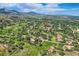 Expansive aerial shot features homes nestled amongst trees and rock formations in a scenic, mountainous landscape at 6451 Crestbrook Dr, Morrison, CO 80465