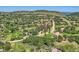 Wide aerial view showcases homes nestled among lush greenery and striking rock formations in a mountain community setting at 6451 Crestbrook Dr, Morrison, CO 80465