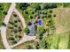 Top-down aerial view features a home with a pool, landscaped yard, and mature trees, providing a private oasis at 6451 Crestbrook Dr, Morrison, CO 80465