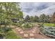 Expansive backyard featuring lush landscaping, swimming pool, hammock and beautiful foliage at 6451 Crestbrook Dr, Morrison, CO 80465